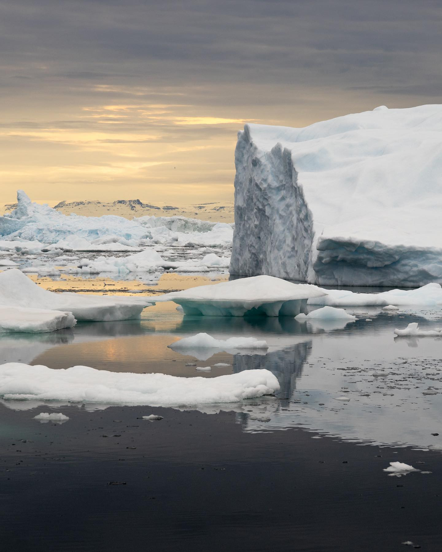 The World of Ice & Fire. #greenland #midnightsun #iceberg #icefjord #canoneosr6markii #eosr6mii #sigma24105art at 105mm f/9 @worldofgreenland #landscapephotography