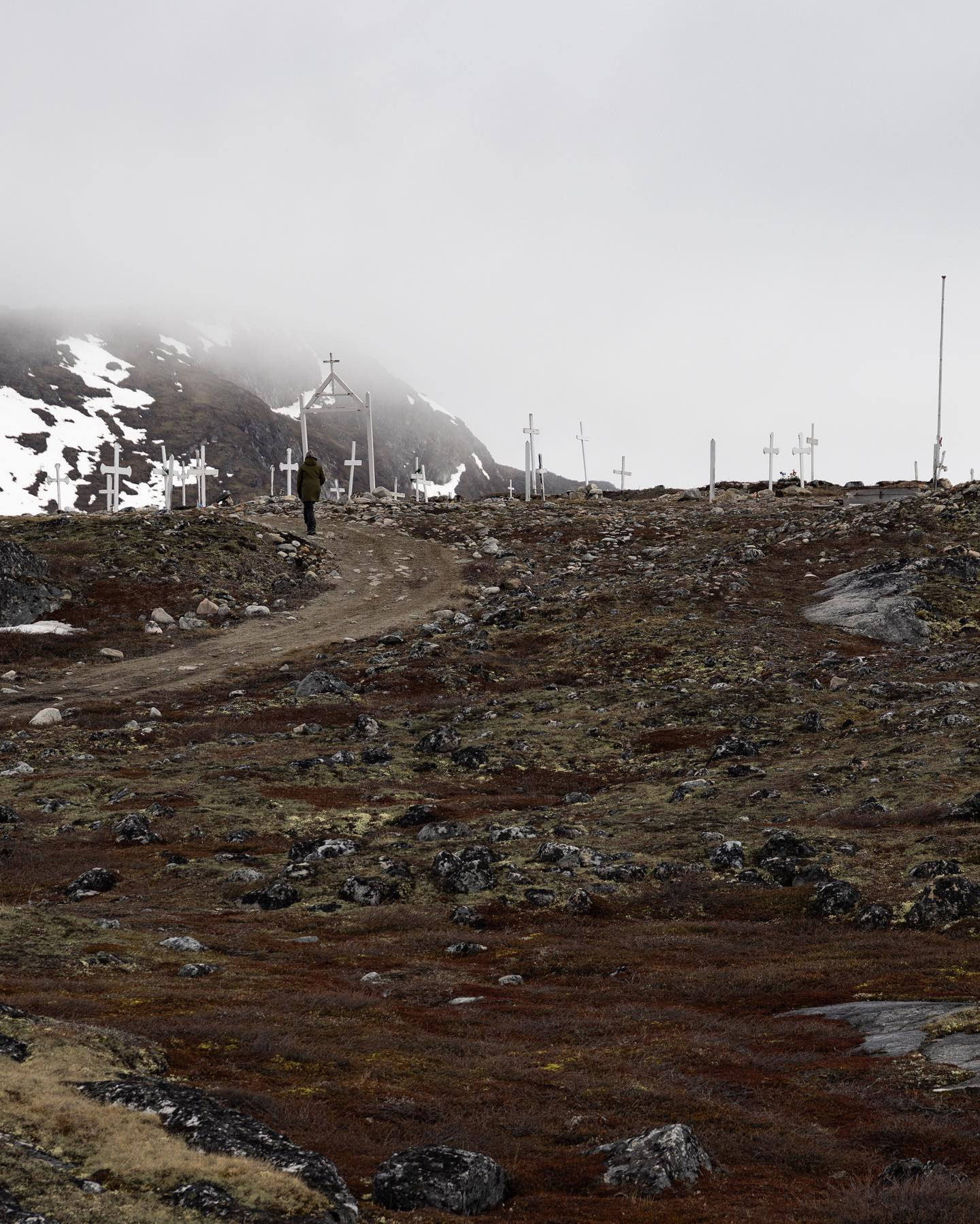 Ilimanaq cemetery. In Greenland graves are marked with white wooden crosses instead of headstones. Spare graves are dug during summer as the soil is frozen solid all winter. #canoneosr6markii #eosr6markii #sigma24105art  #greenland