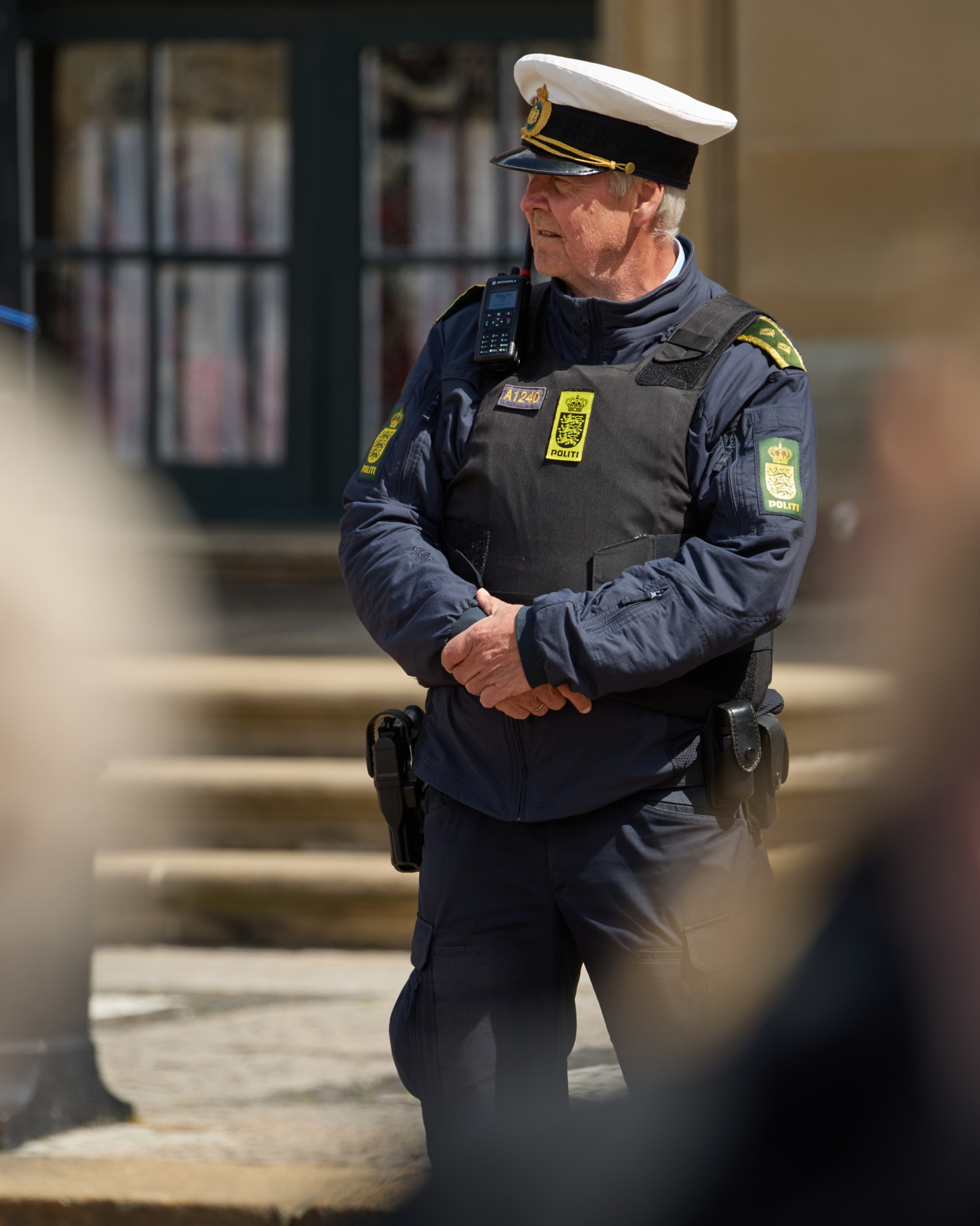 Police officer watching the crowd in front of Amalienborg Castle, Copenhagen